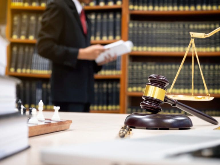 Detail of a judge sitting at his desk.