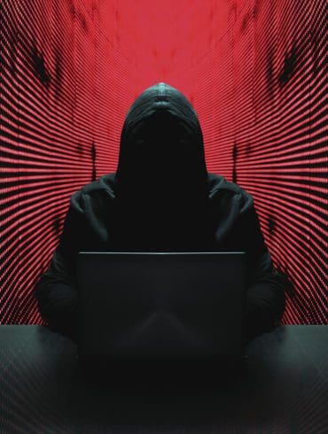 Anonymous hacker in front of his computer. | iStock photo