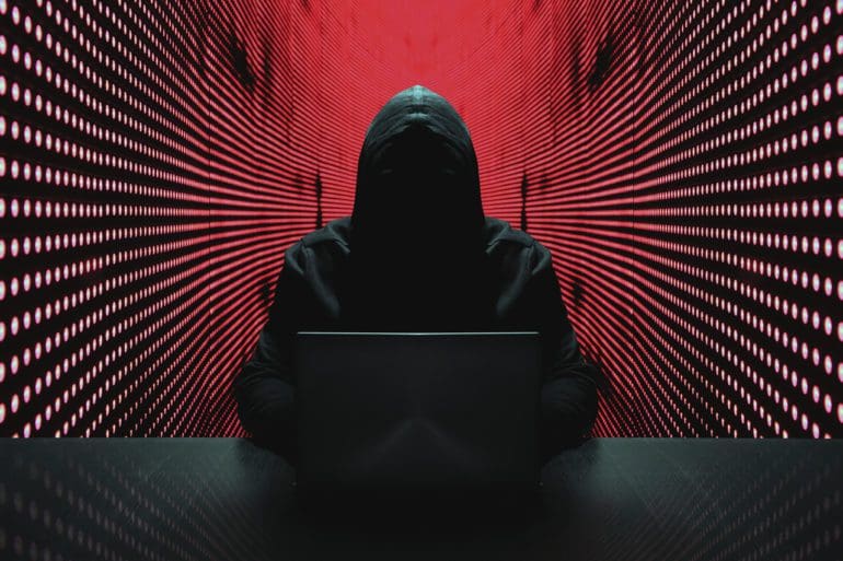 Anonymous hacker in front of his computer. | iStock photo