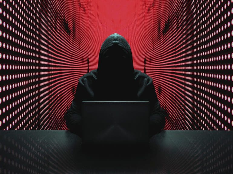 Anonymous hacker in front of his computer. | iStock photo