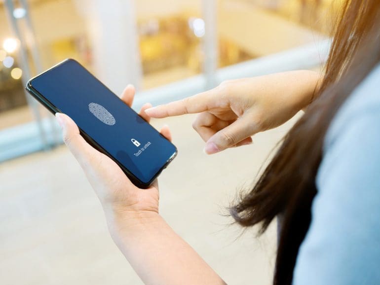 Hand women holding smartphone and scan fingerprint biometric identity for unlock her mobile phone