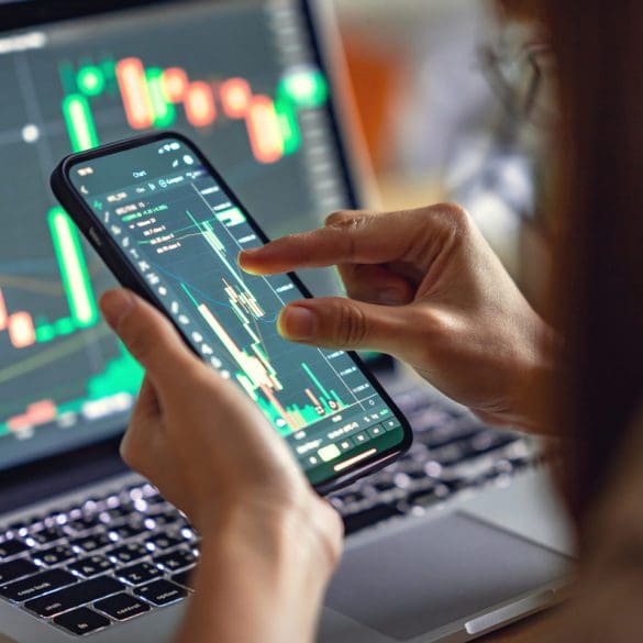 Closeup - Woman is checking Bitcoin price chart on digital exchange on smartphone, cryptocurrency future price action prediction.