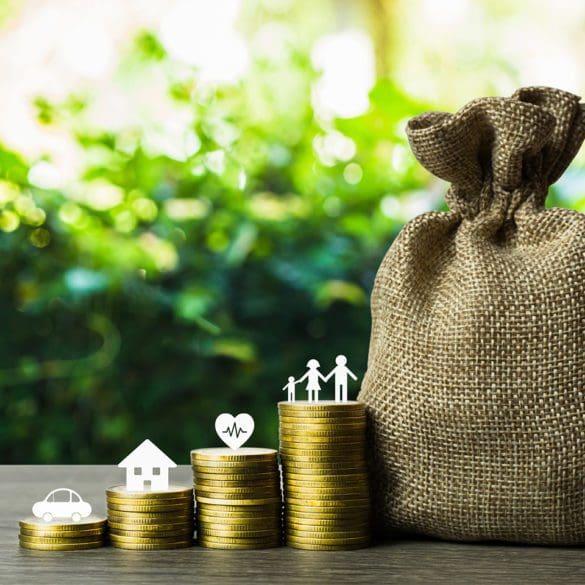 Savings money for the future concepts. Family member, car, house, healthy on stack of coins with money bag on wood table. Depicts saving for wealth and life. fundraising concept.