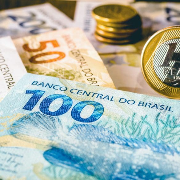 In this photo illustration being displayed one hundred and two hundred reais bills and a one reais coin highlighted. The Real is the current money in Brazil.