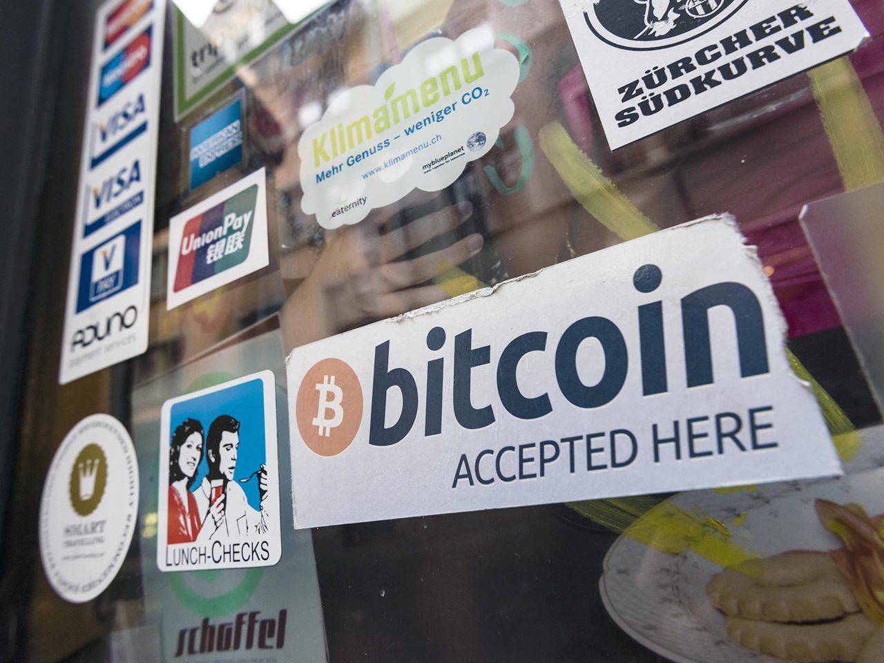 "Bitcoin accepted" sign in the window of "Kafi Schoffel", a coffee bar in Zurich downtown that accepts Bitcoin as means of payment and houses a Bitcoin ATM.