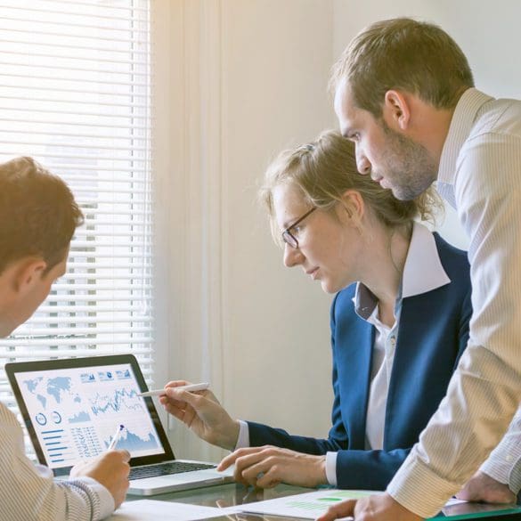 Team of finance people discussing charts and key performance indicator (KPI) on computer screen with business intelligence (BI) in meeting room, corporate revenue, fintech