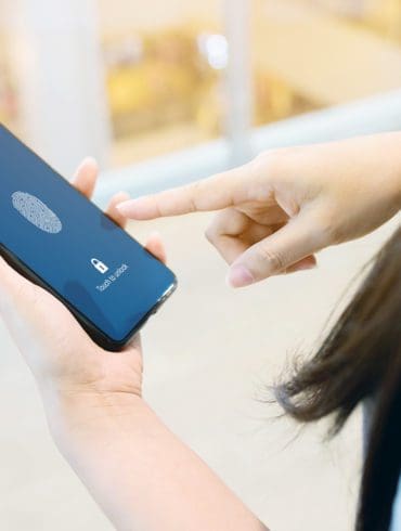 Hand women holding smartphone and scan fingerprint biometric identity for unlock her mobile phone