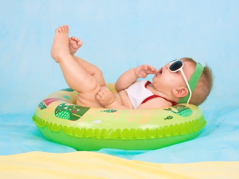 baby in floaty in water