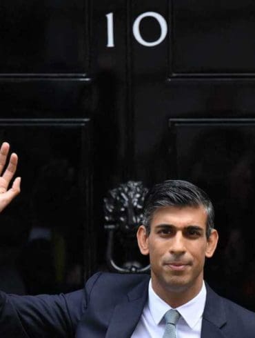 Britain's newly appointed Prime Minister Rishi Sunak waves as he poses outside to door to 10 Downing Street in central London, on October 25, 2022, after delivering his first speech as prime minister. - Rishi Sunak was on Tuesday appointed as Britain's third prime minister this year, after outgoing leader Liz Truss submitted her resignation to King Charles III. (Photo by Daniel LEAL / AFP) (Photo by DANIEL LEAL/AFP via Getty Images)