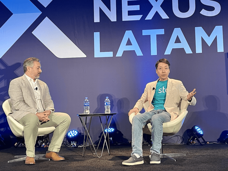 Moderator Jacob Haar, CIM, chats with Bin Chen, Stori, on the Scaling Financial Inclusion Sustainably keynote on the main stage.