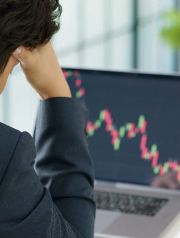 Stressed businessman feeling desperate on crisis stock market, investment concept.