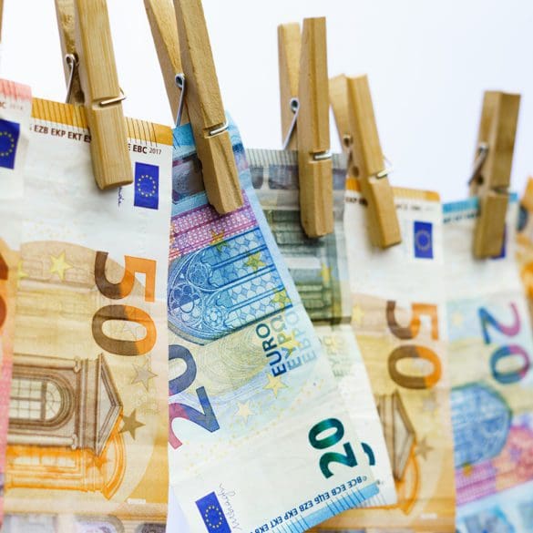 euro banknotes hung on a clothesline with clothespins in Málaga, Andalusia, Spain