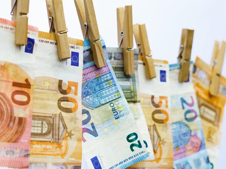 euro banknotes hung on a clothesline with clothespins in Málaga, Andalusia, Spain