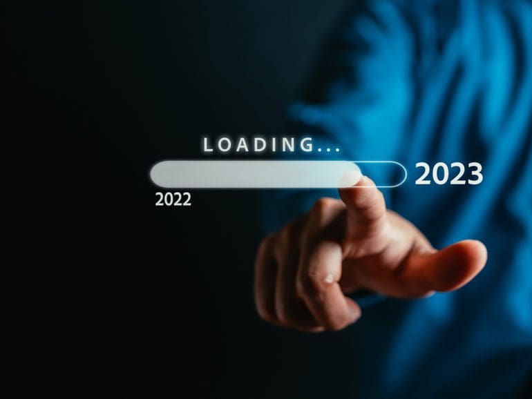 Businessman touching to virtual download bar and loading for New Year and changing year 2022 to 2023. start up planing business in next years concept.