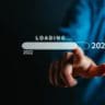 Businessman touching to virtual download bar and loading for New Year and changing year 2022 to 2023. start up planing business in next years concept.
