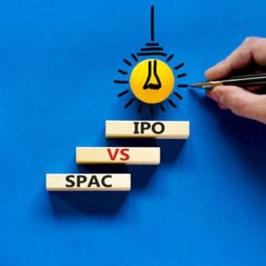 SPAC vs IPO symbol. Blocks with words 'SPAC, special purpose acquisition company' and 'IPO, initial public offering' on blue background, copy space. Business and SPAC vs IPO concept.
