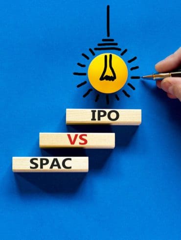 SPAC vs IPO symbol. Blocks with words 'SPAC, special purpose acquisition company' and 'IPO, initial public offering' on blue background, copy space. Business and SPAC vs IPO concept.