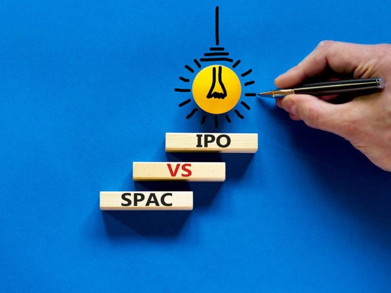 SPAC vs IPO symbol. Blocks with words 'SPAC, special purpose acquisition company' and 'IPO, initial public offering' on blue background, copy space. Business and SPAC vs IPO concept.