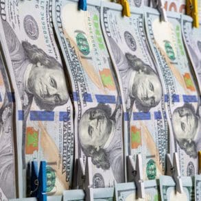 Anti-Money Laundering concept. AML. US Dollars hanging on ropes