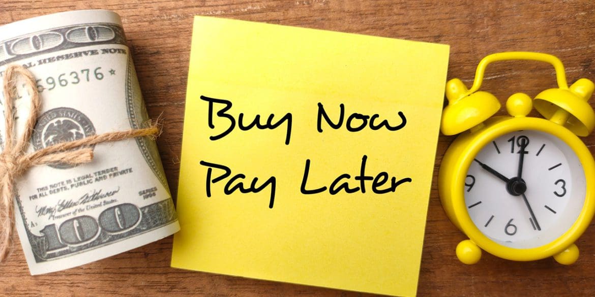 Banknotes,clock and sticky note with the word Buy Now Pay Later.