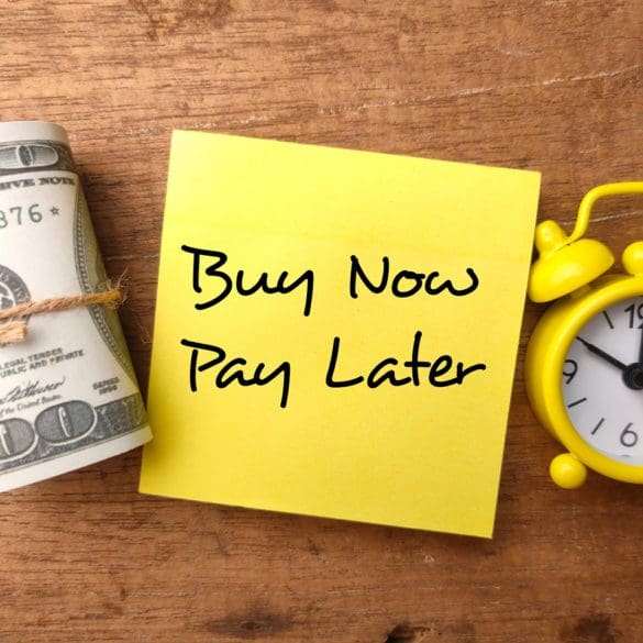 Banknotes,clock and sticky note with the word Buy Now Pay Later.