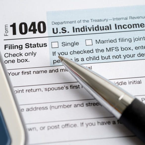 Tax Return form 1040 with USA America flag and dollar banknote, U.S. Individual Income.