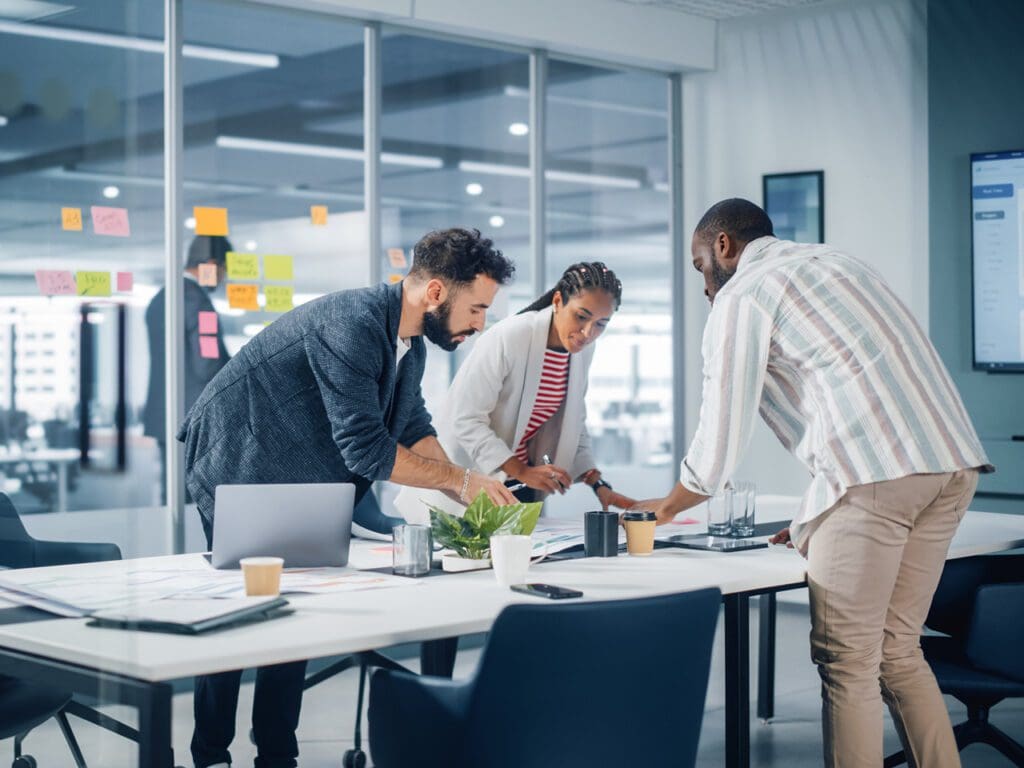 Diverse Team of Professional Businesspeople Meeting in the Office Conference Room. Creative Team Around Table, Black Businesswoman, African-American Digital Entrepreneur and Hispanic CEO Talking.