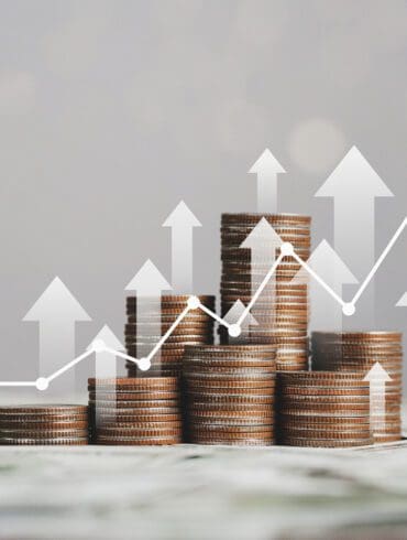 stack of silver coins with trading chart in financial concepts and financial investment business stock growth