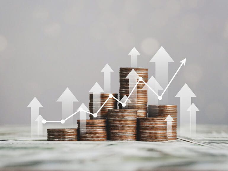 stack of silver coins with trading chart in financial concepts and financial investment business stock growth