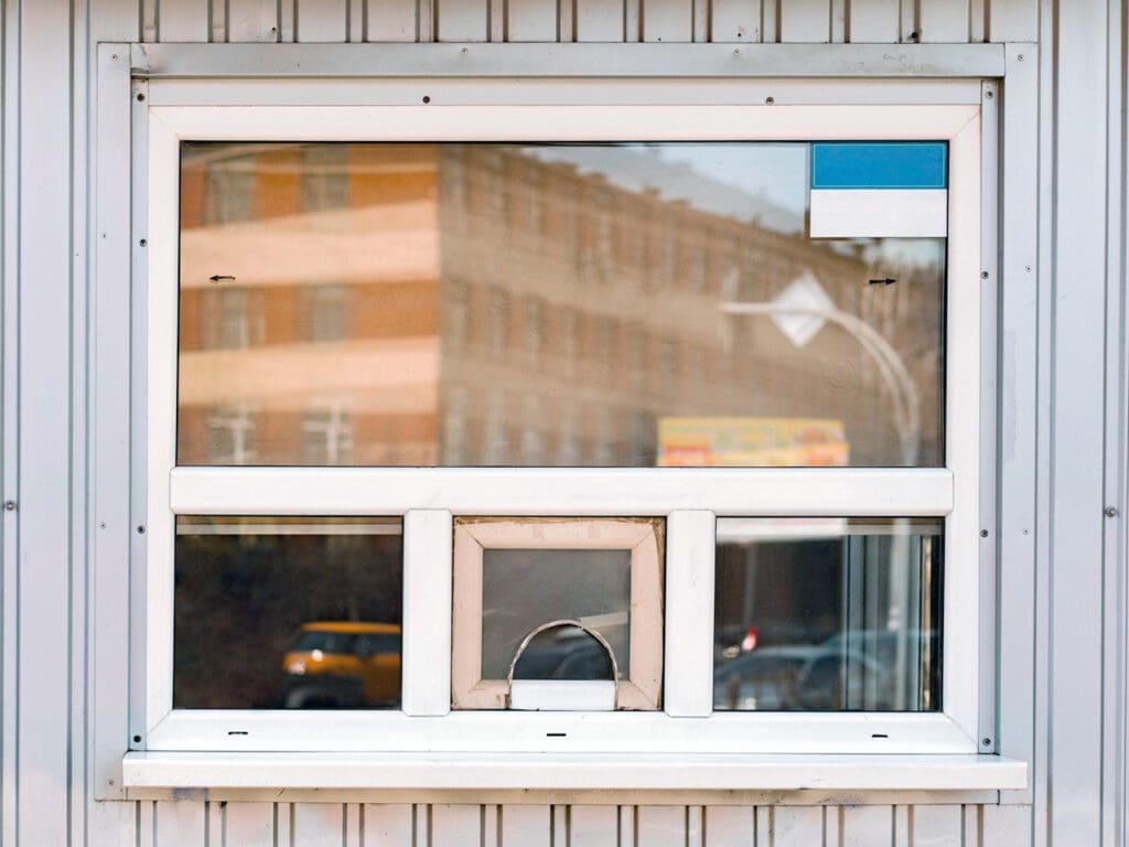 Glass counter cashier cabin with plastic windows and aluminium siding facade. Cash box. department. Ticket. Transportation. Ticketing. Money. Control