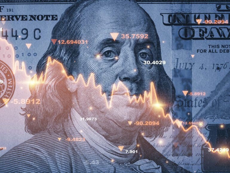 Benjamin Franklin face on USD dollar banknote with red decreasing stock market graph chart for symbol of economic recession crisis concept.