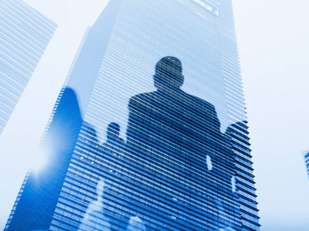 Reflection of people in skyscraper windows