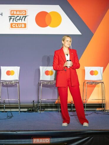 A woman stands on the Fraud Fight Club stage