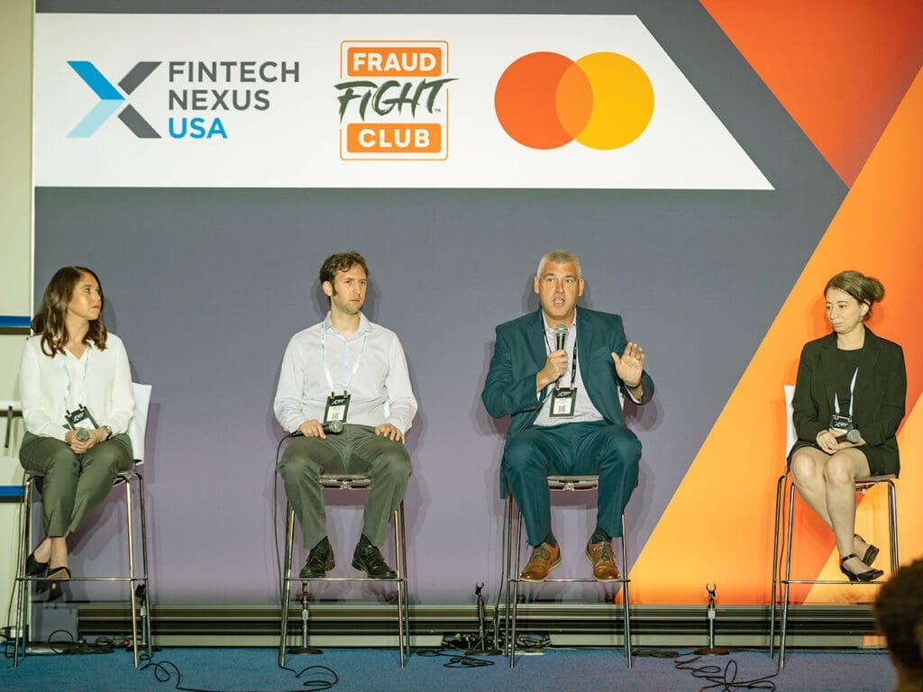 Four people sit on stools on the Fraud Fight Club stage at Fintech Nexus USA 2023.