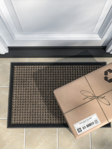 Express delivery, e-commerce online purchase concept. Parcel box on mat near front door. 3d illustration