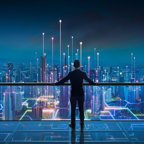 Businessman standing at transparent glass floor on rooftop with night Smart city panoramic view. Business success with smart technology concept