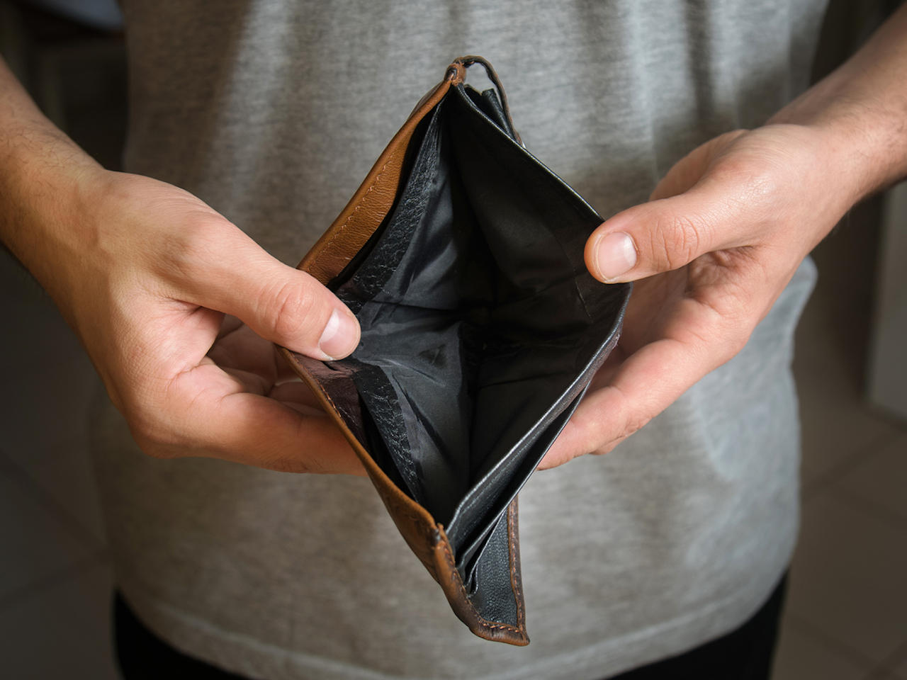 Businessman has no money. Unemployed and bankrupt man looks into his empty wallet. Stress crisis, unemployed businessmen waiting for new job, recession situation and hopelessness