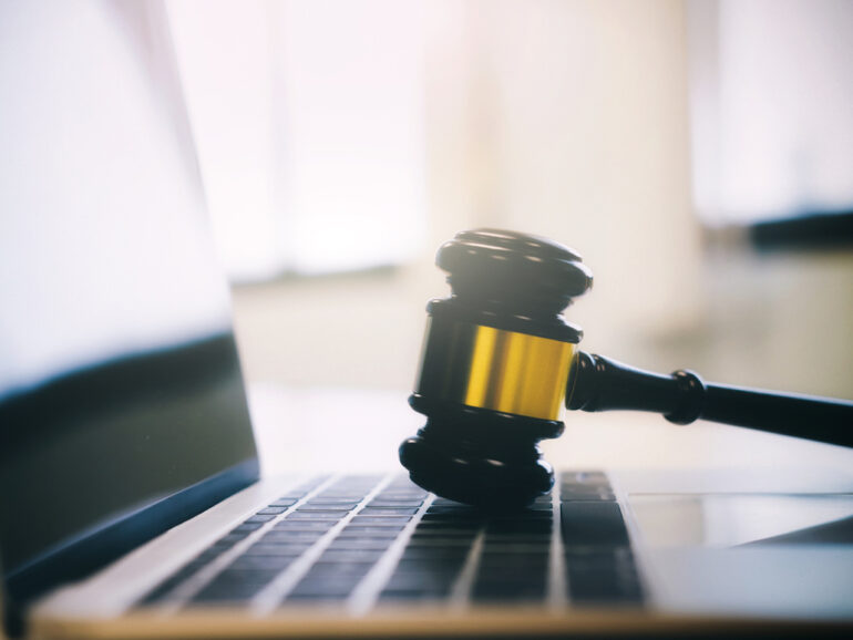 Auction or law gavel on a computer keyboard. Law legal technology